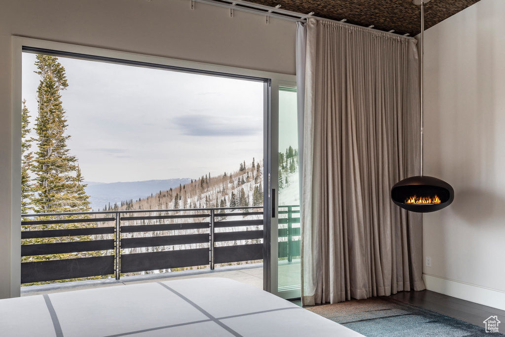 Unfurnished bedroom featuring a mountain view and baseboards