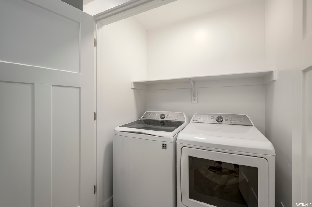 Laundry room featuring washer and clothes dryer