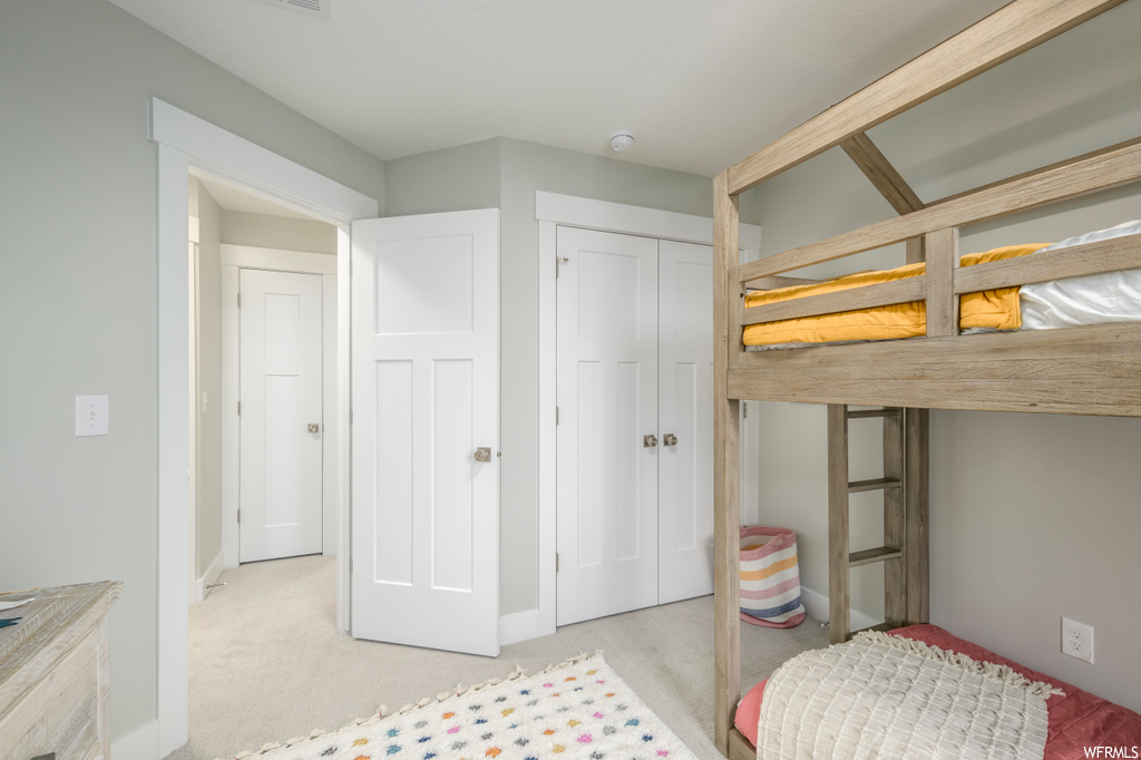 Bedroom featuring a closet and light colored carpet