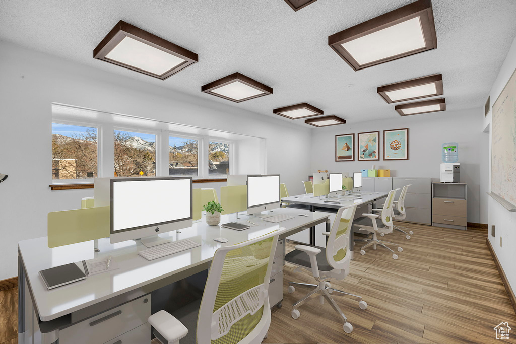 Office featuring a textured ceiling and light hardwood / wood-style floors