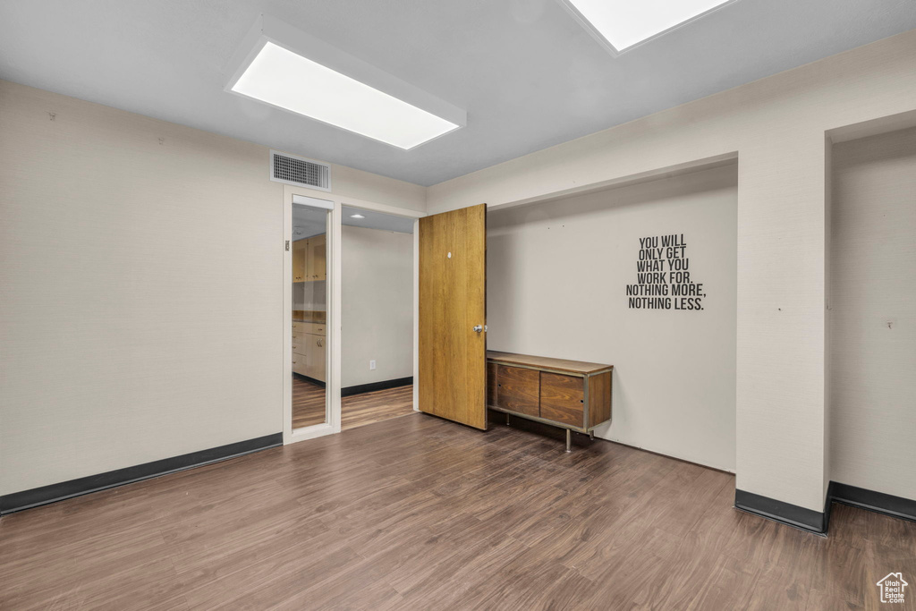 Unfurnished room featuring dark hardwood / wood-style floors