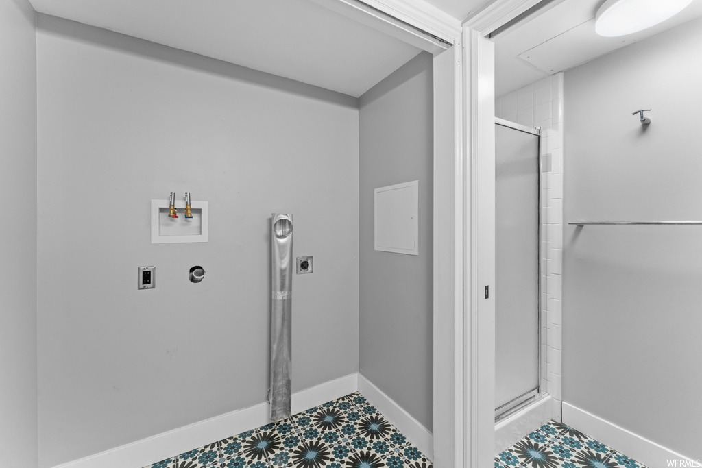Bathroom with tile flooring and an enclosed shower