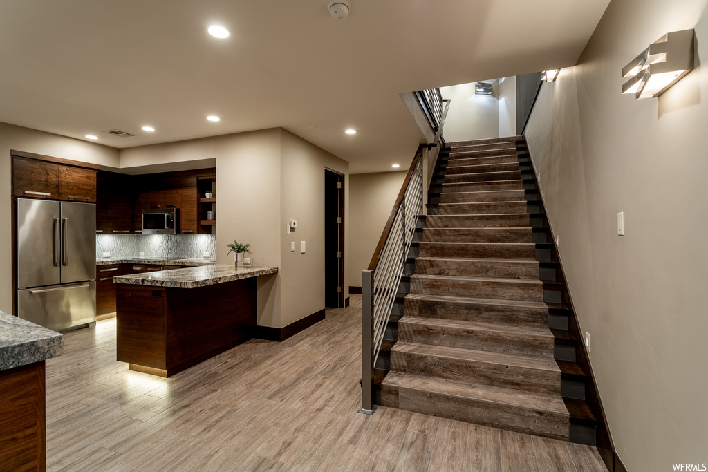 Staircase featuring light hardwood / wood-style floors