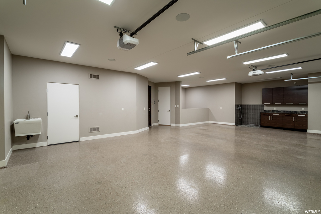 Garage with sink and a garage door opener