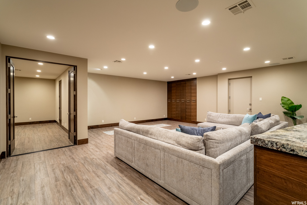 Living room with light hardwood / wood-style floors