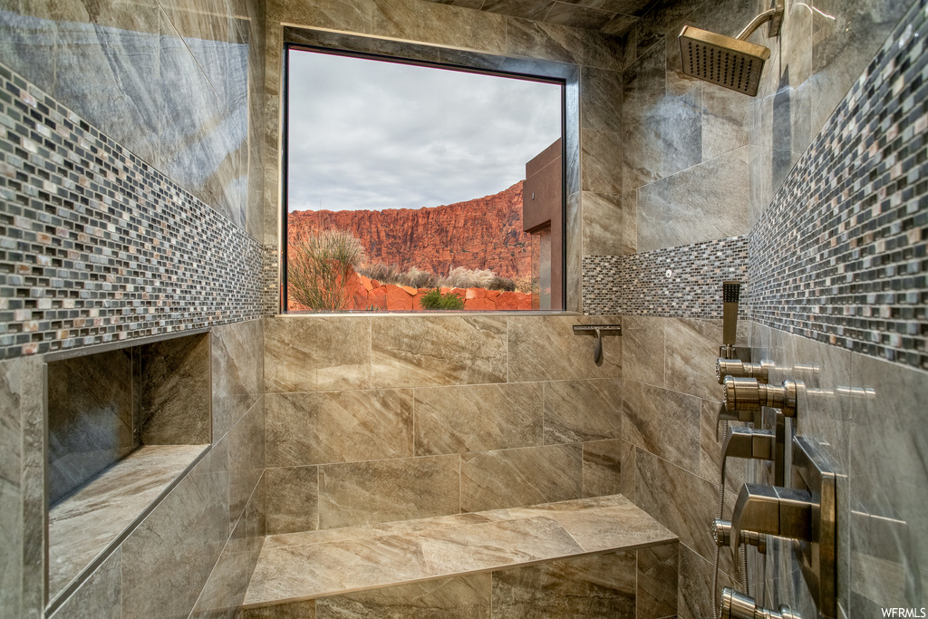 Bathroom with tile walls and a tile shower