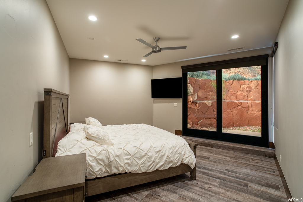 Bedroom featuring dark wood-type flooring and ceiling fan