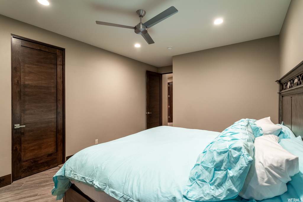 Bedroom featuring light hardwood / wood-style floors and ceiling fan