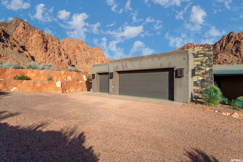 View of front of house with a garage and a mountain view