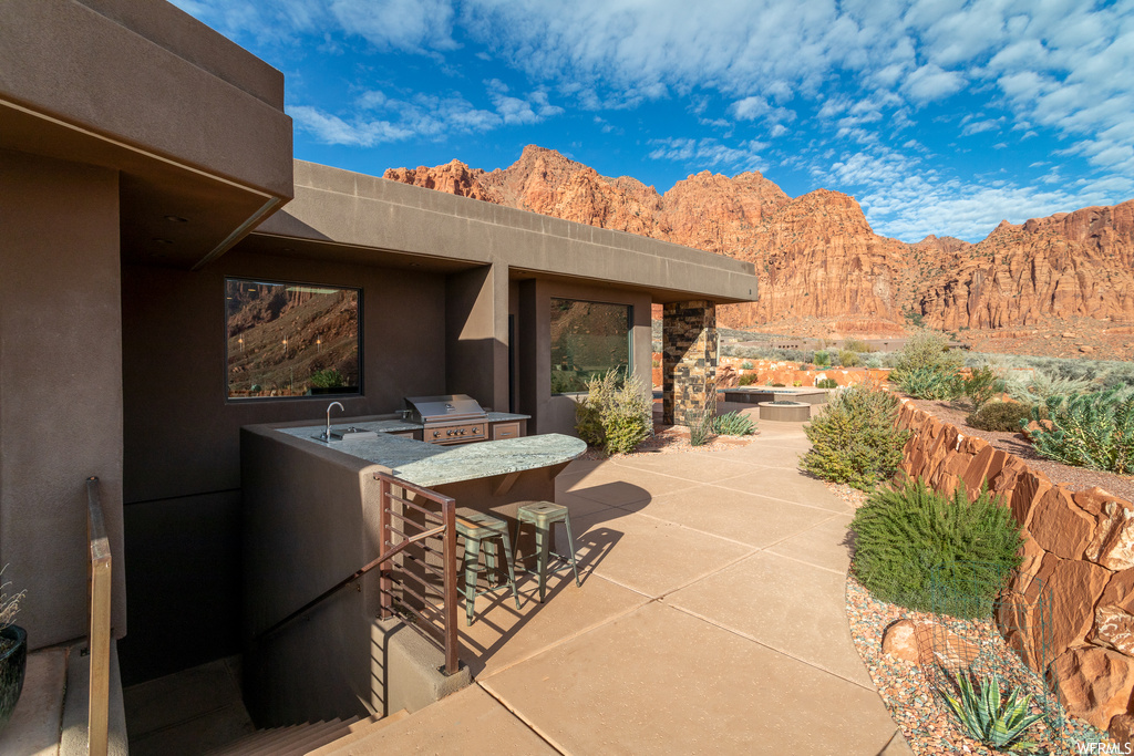 View of patio / terrace featuring area for grilling and a mountain view