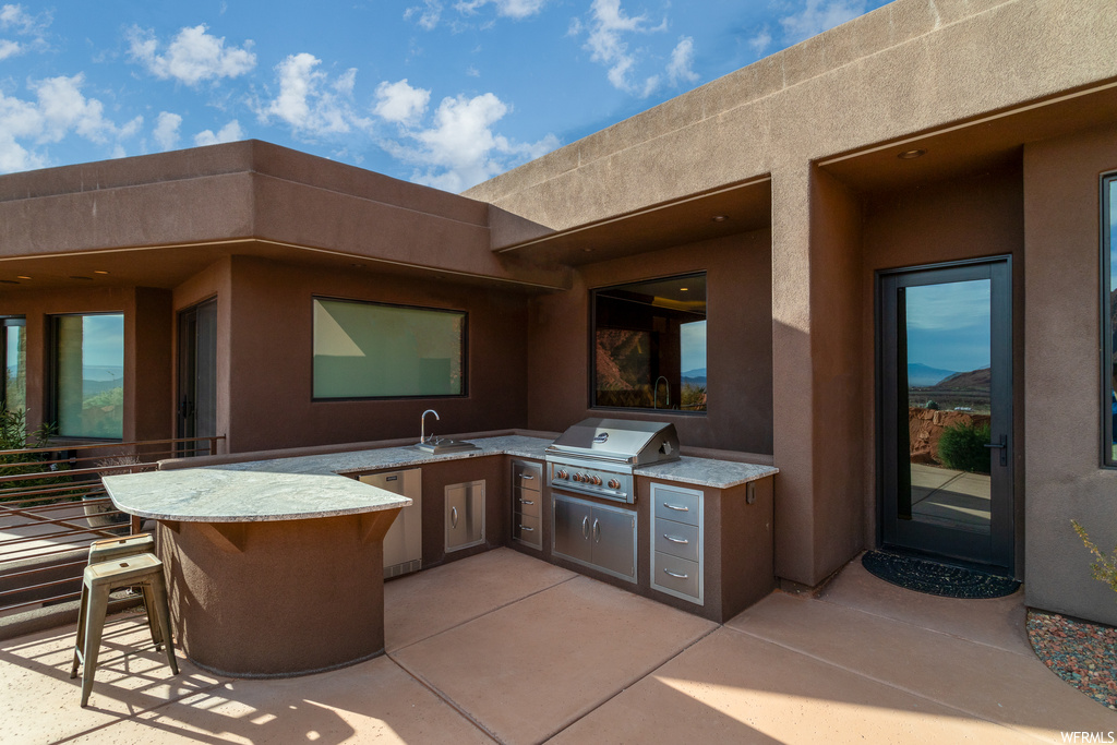 View of terrace with a grill and an outdoor kitchen