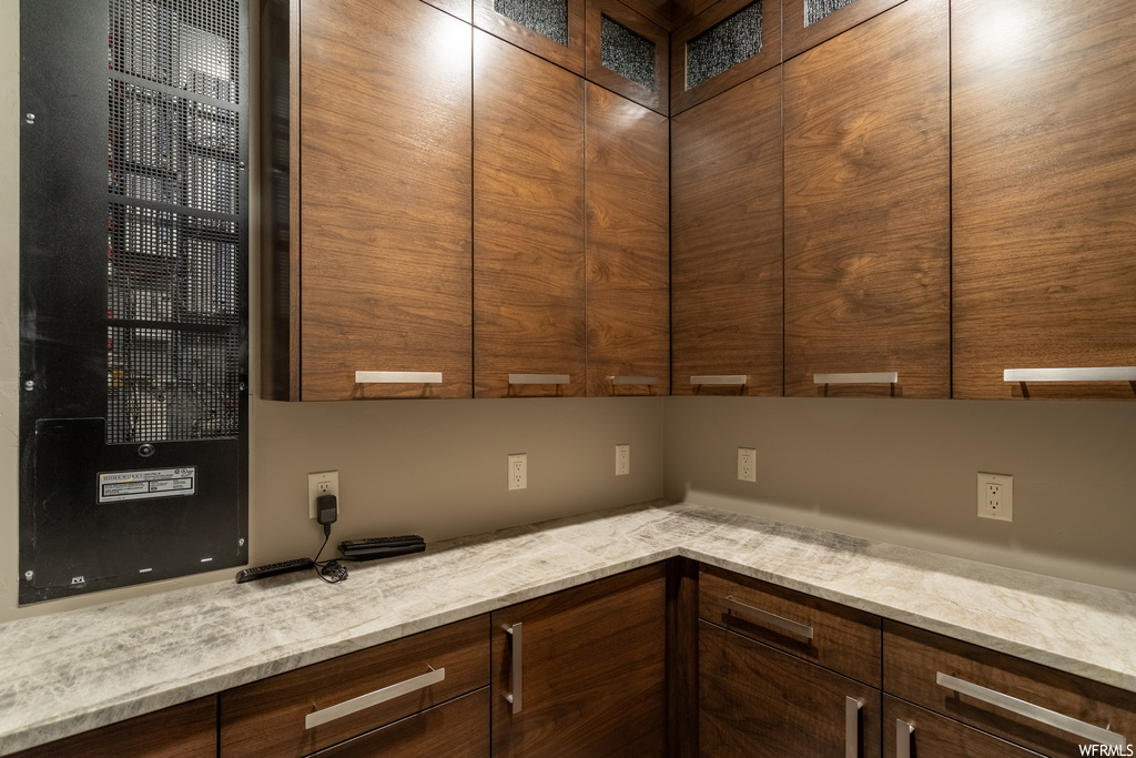 Kitchen featuring light stone counters