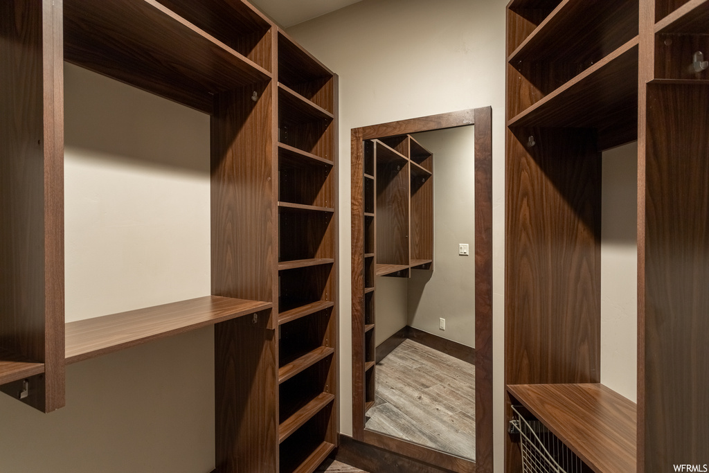 Walk in closet featuring wood-type flooring