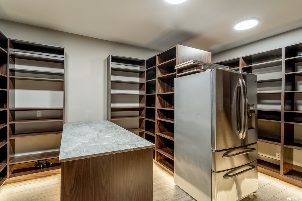 Spacious closet with light wood-type flooring