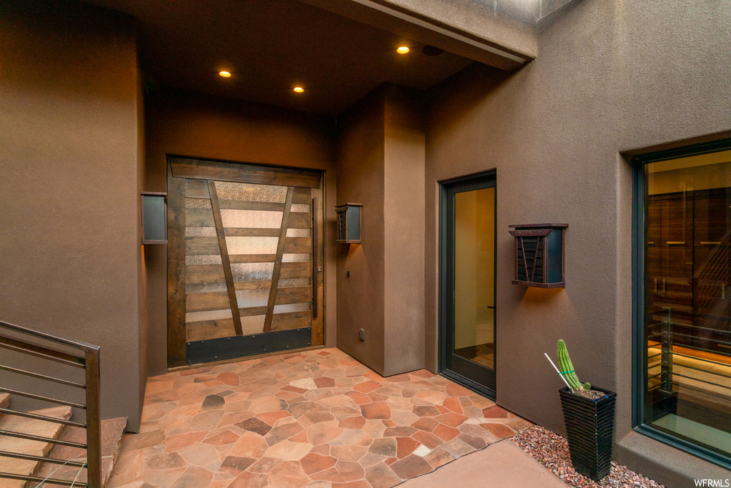 Doorway to property with a patio area