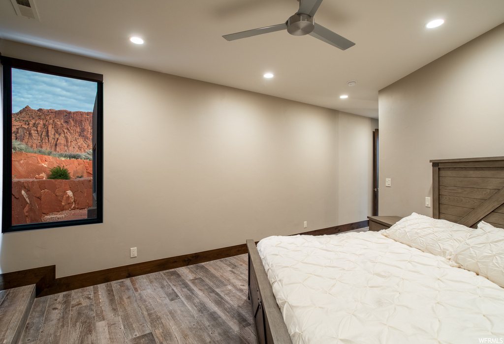 Bedroom featuring dark hardwood / wood-style flooring and ceiling fan