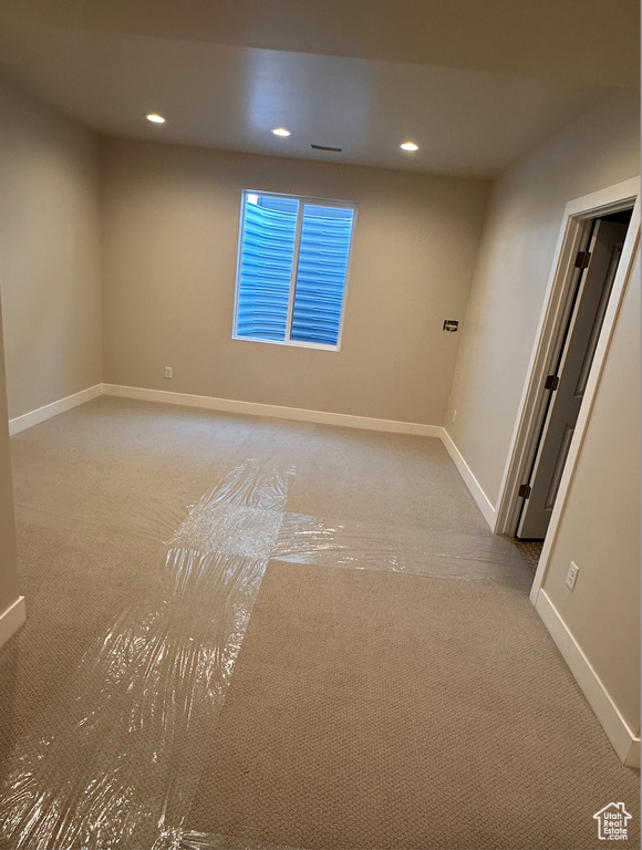 Empty room featuring light carpet