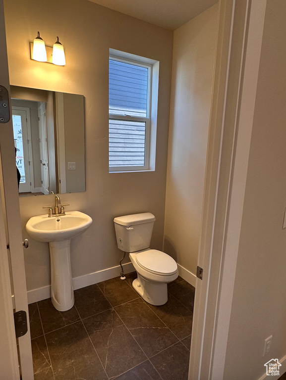 Bathroom with toilet and tile patterned floors