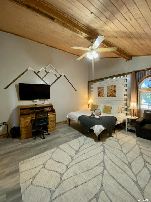 Bedroom with light wood-type flooring, wood ceiling, beam ceiling, and ceiling fan
