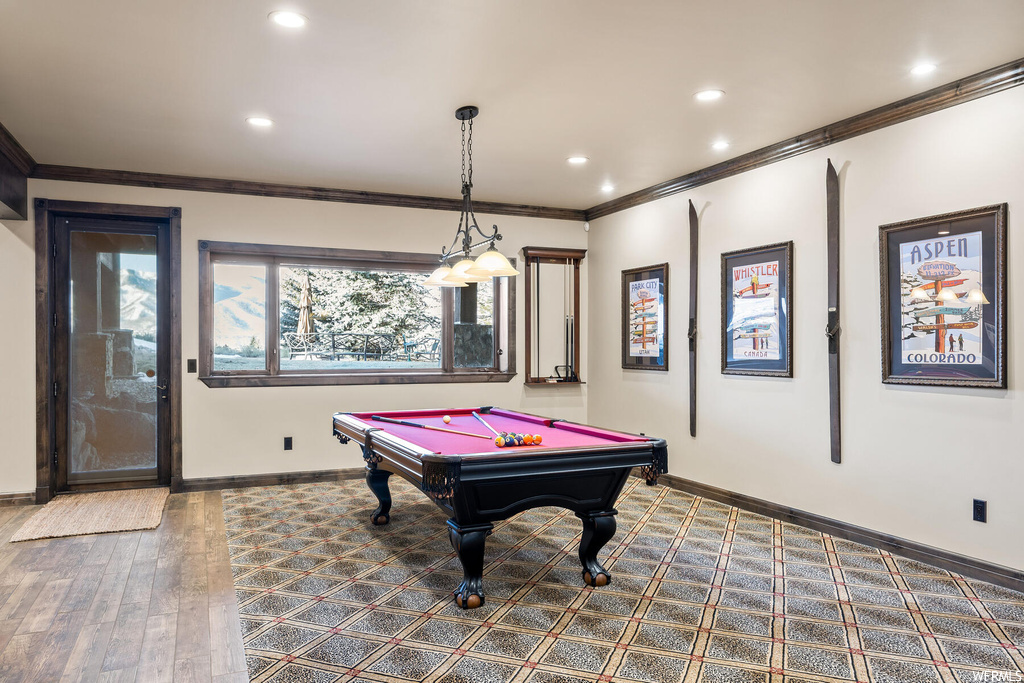 Game room featuring ornamental molding, billiards, and dark hardwood / wood-style floors