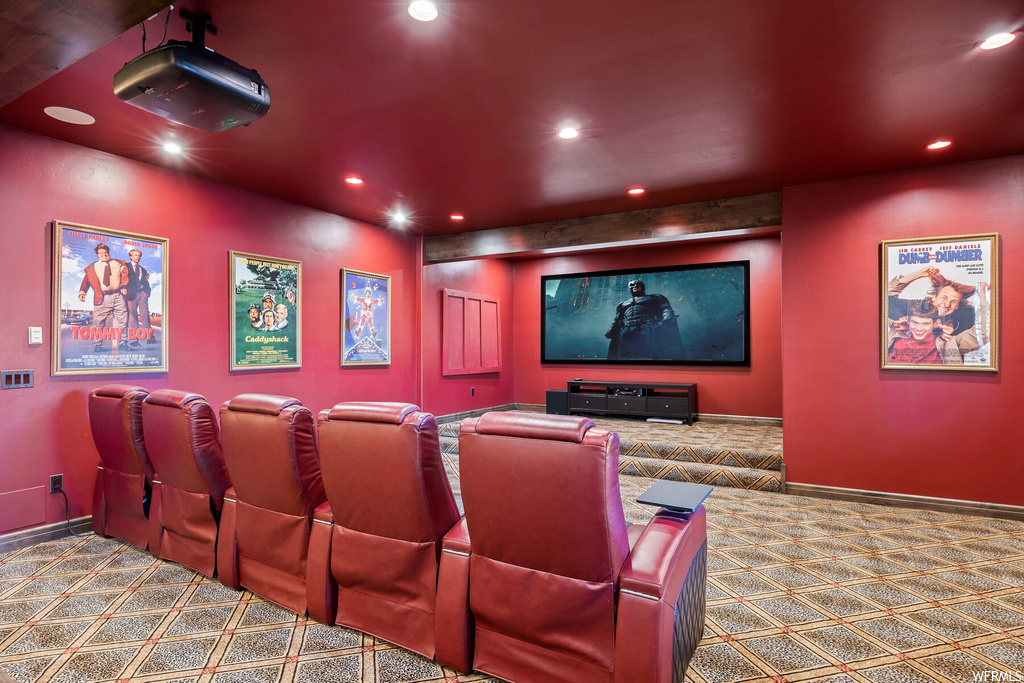 Home theater room featuring dark carpet
