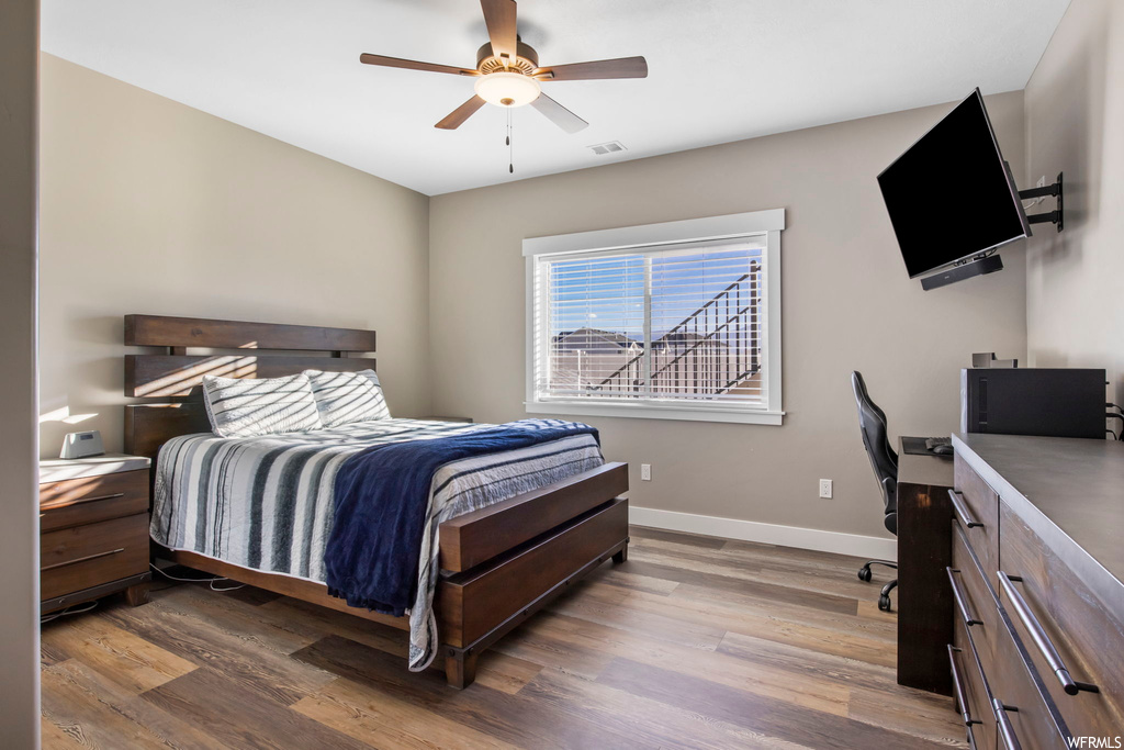 Bedroom featuring hardwood / wood-style floors and ceiling fan