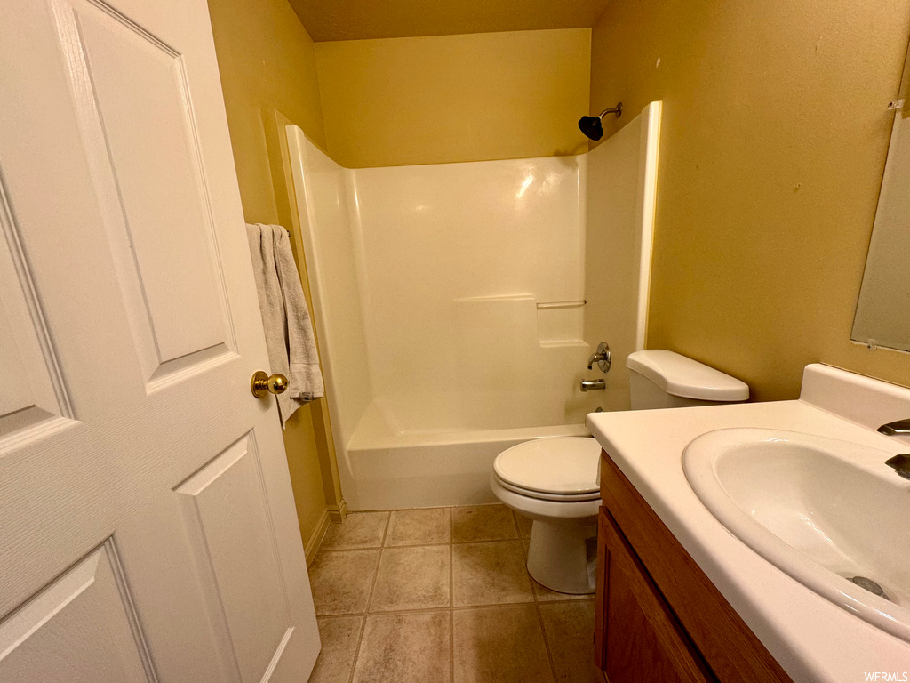 Full bathroom with tile floors, vanity, shower / bathing tub combination, and toilet
