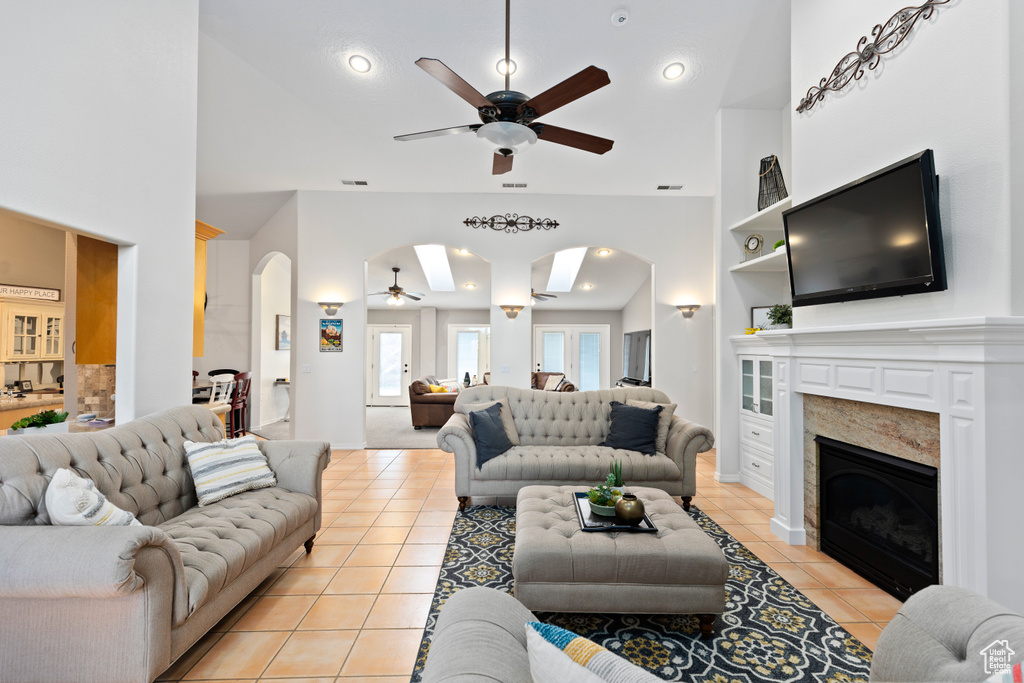 Living room featuring light tile floors and ceiling fan