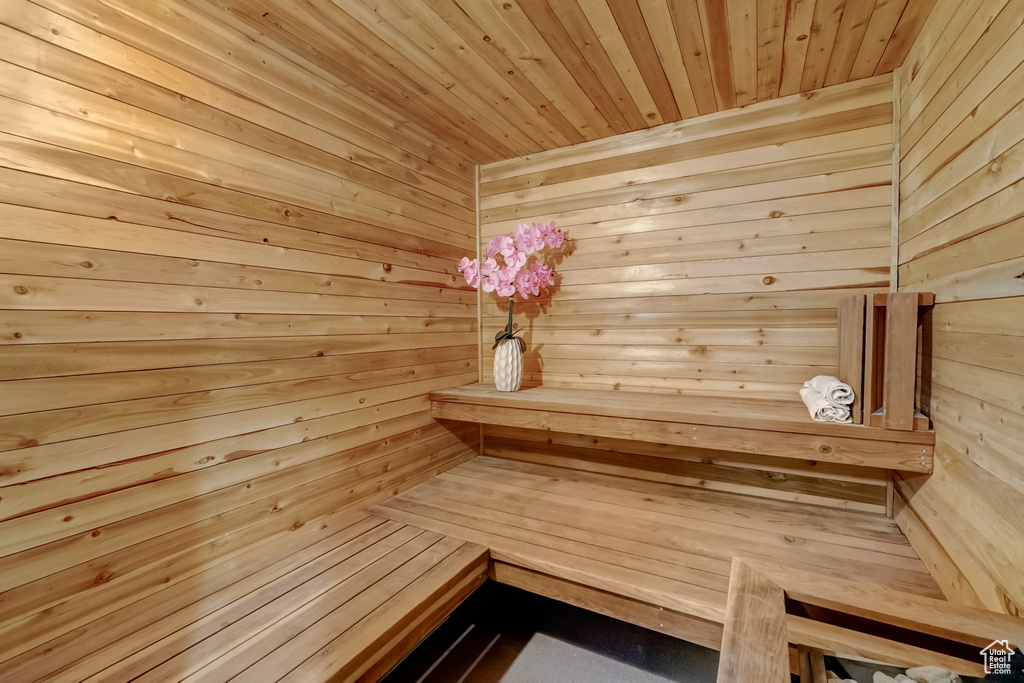 View of sauna / steam room featuring wood walls and wooden ceiling