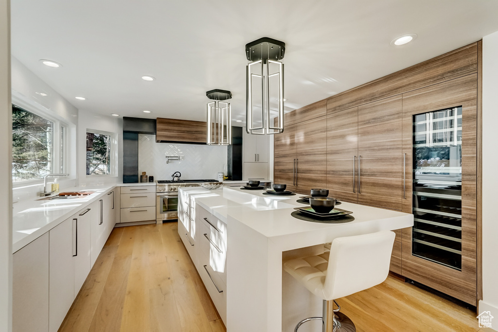 Kitchen featuring white cabinets, sink, and a center island