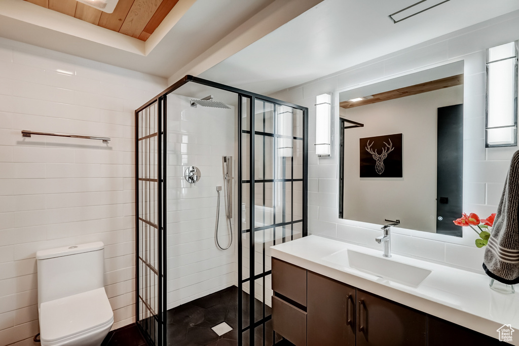 Bathroom with a shower with shower door, toilet, wood ceiling, and large vanity