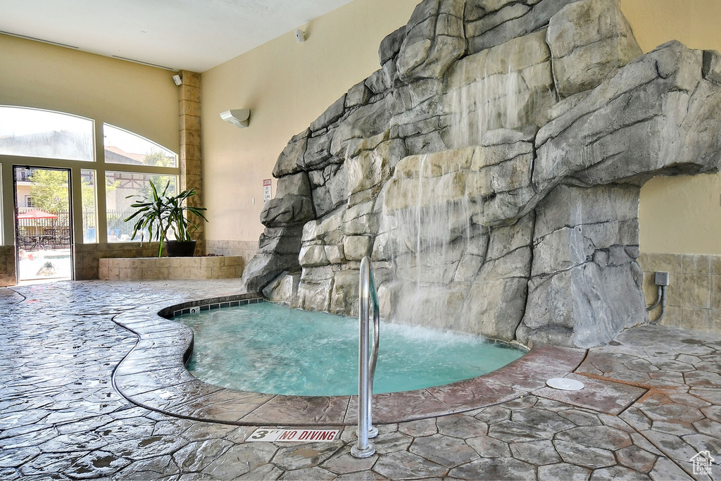View of swimming pool with an indoor in ground hot tub