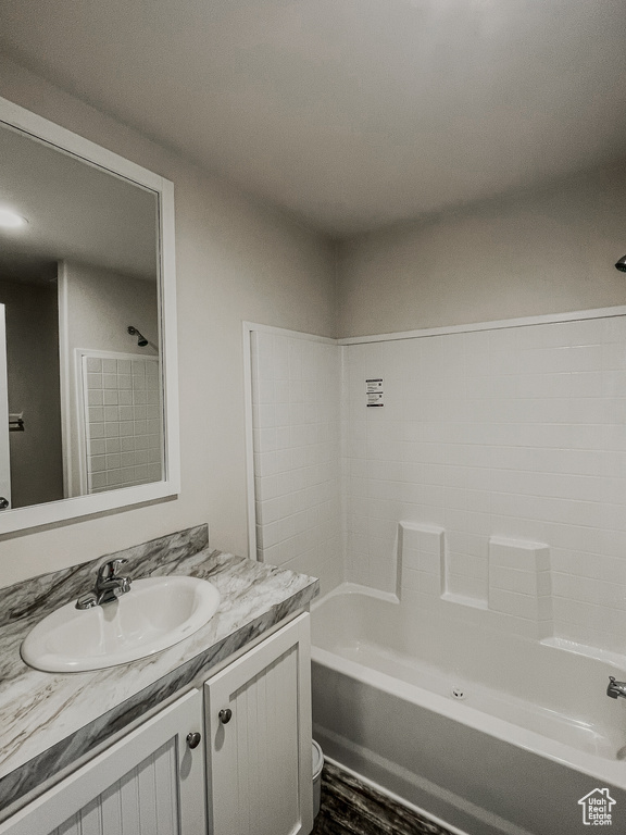 Bathroom with vanity, shower / bathtub combination, and hardwood / wood-style floors