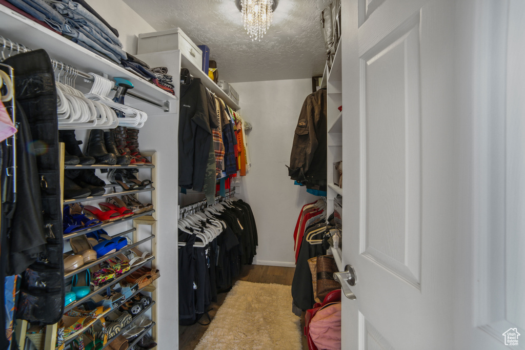 Spacious closet with an inviting chandelier