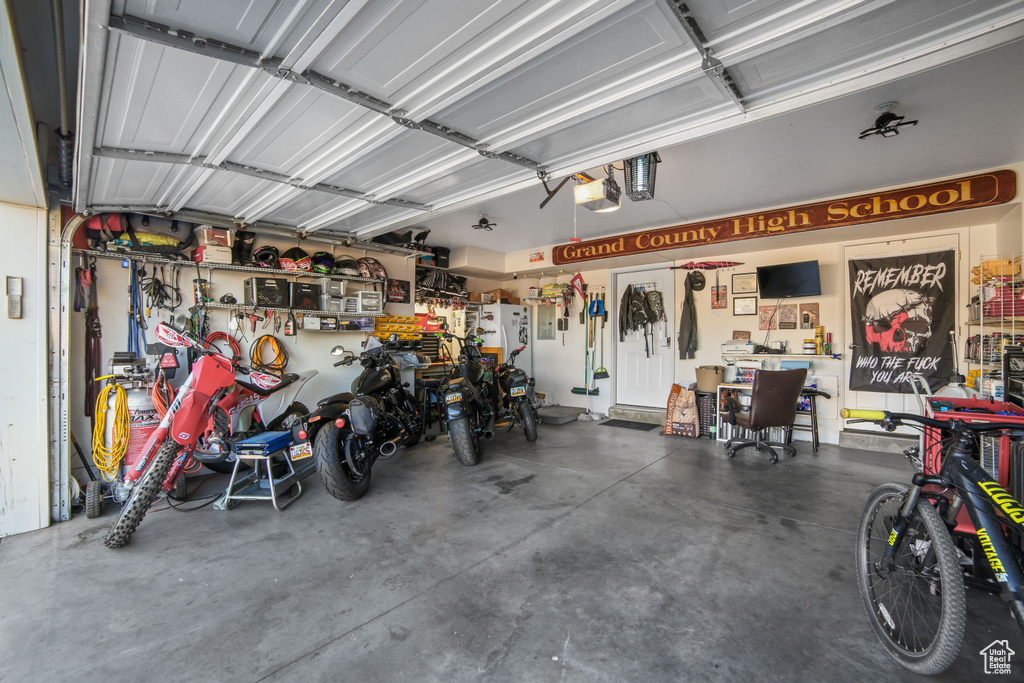Garage with a workshop area and a garage door opener