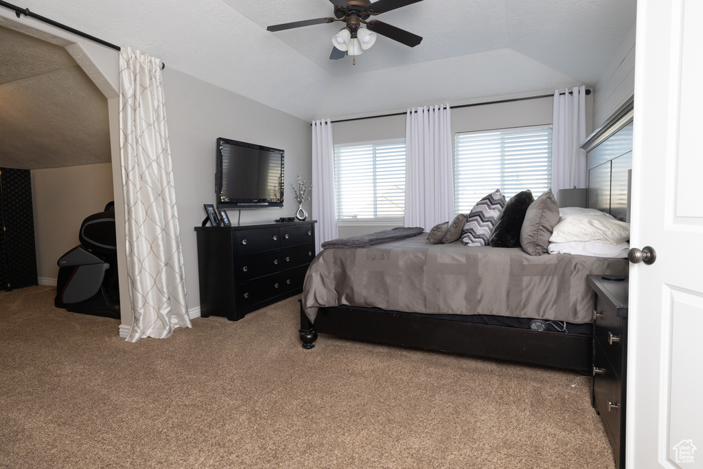 Bedroom with vaulted ceiling, carpet, and ceiling fan