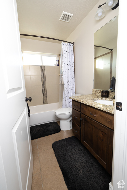 Full bathroom featuring shower / bath combo, large vanity, toilet, and tile flooring