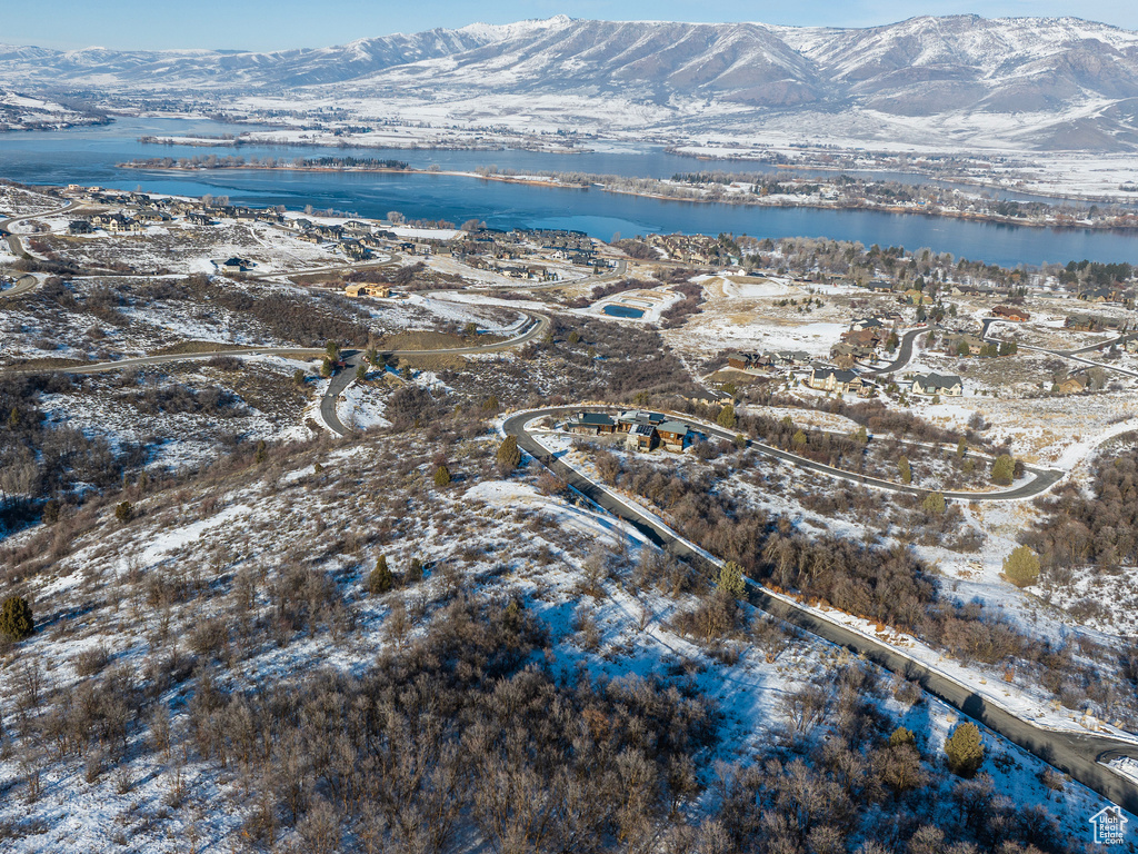 Snowy aerial view with a water and mountain view