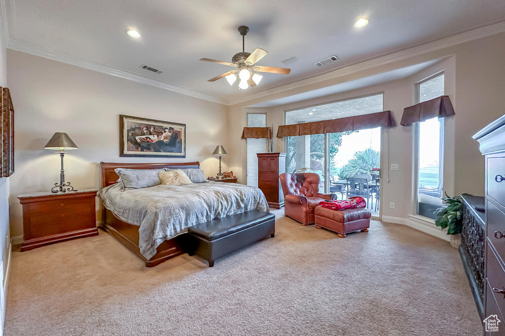 Bedroom with access to exterior, crown molding, ceiling fan, and light colored carpet