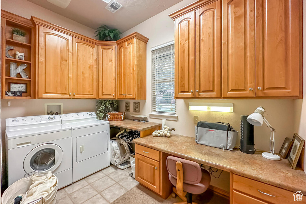 Laundry room featuring hookup for a washing machine, cabinets, light tile flooring, and washer and dryer