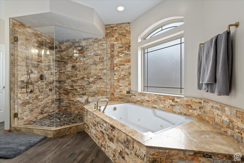 Bathroom with shower with separate bathtub and hardwood / wood-style floors