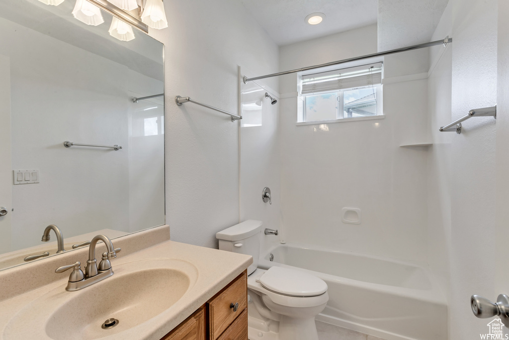 Full bathroom with shower / bath combination, toilet, and vanity