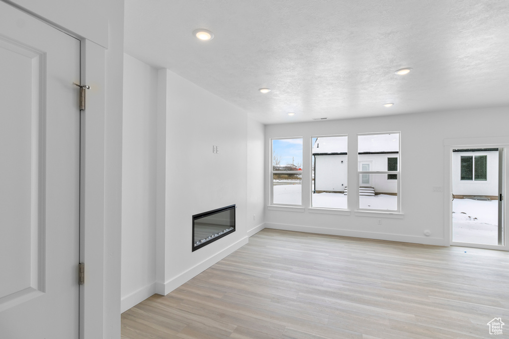 Unfurnished living room with light hardwood / wood-style flooring