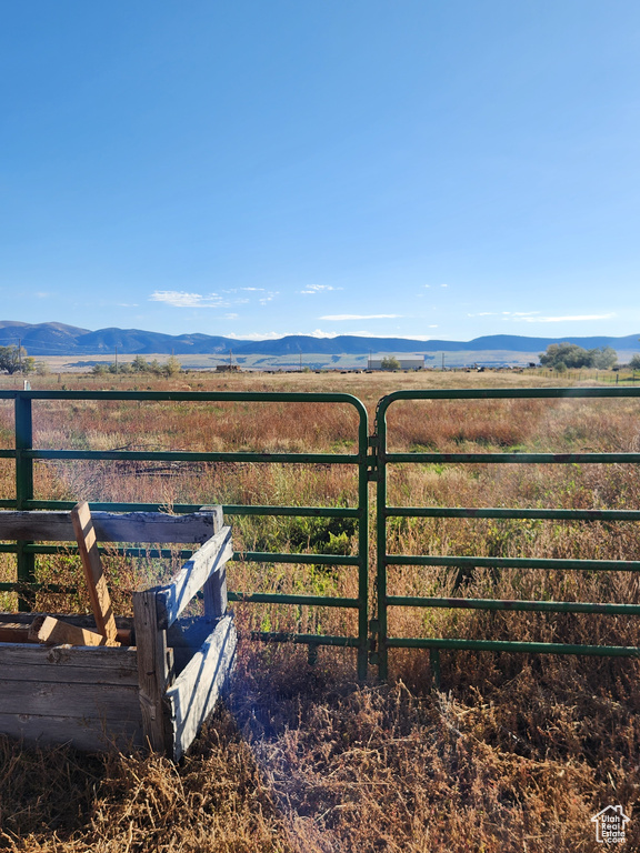 View of gate featuring a rural view and a mountain view