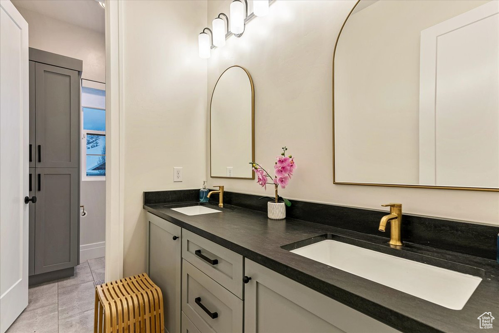 Bathroom with tile floors and double sink vanity