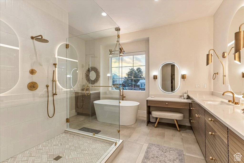 Bathroom with tile floors, large vanity, and plus walk in shower