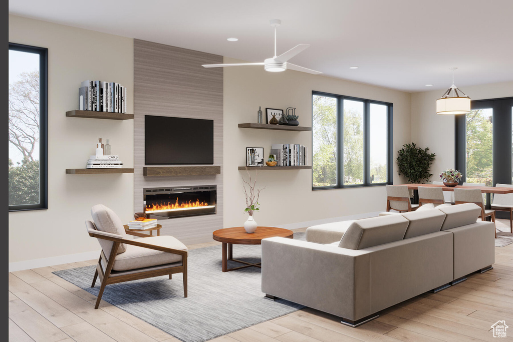 Living room featuring light hardwood / wood-style floors, a large fireplace, and ceiling fan