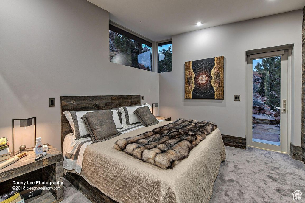 Bedroom featuring access to exterior and light carpet