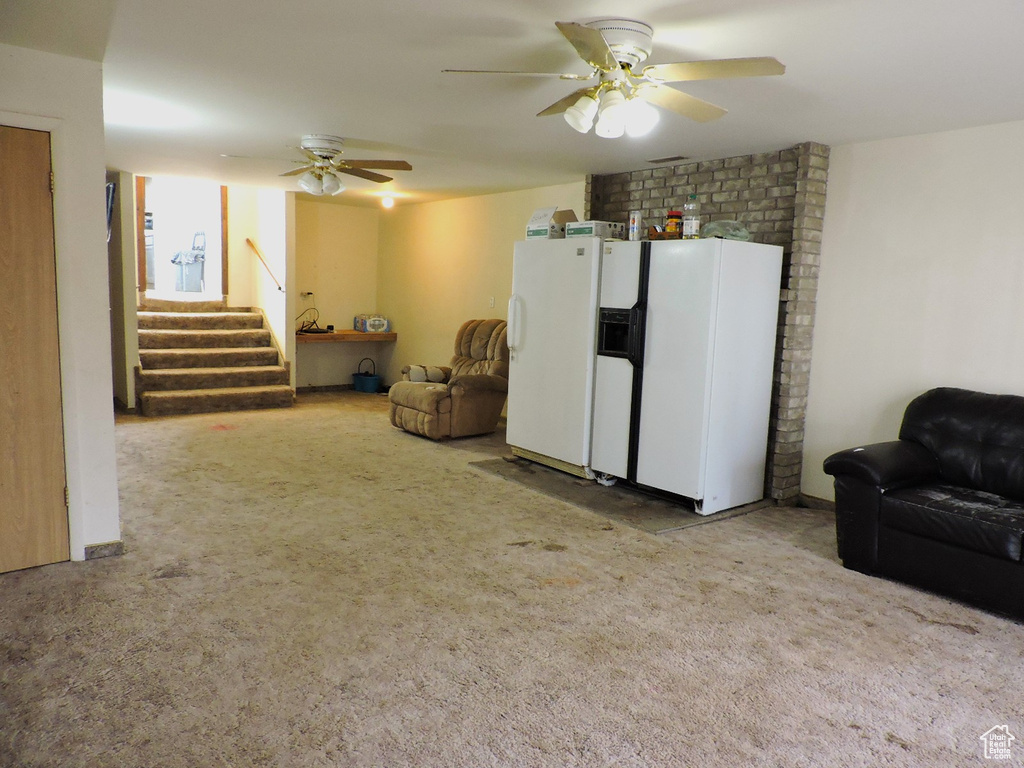 Interior space with light colored carpet and ceiling fan