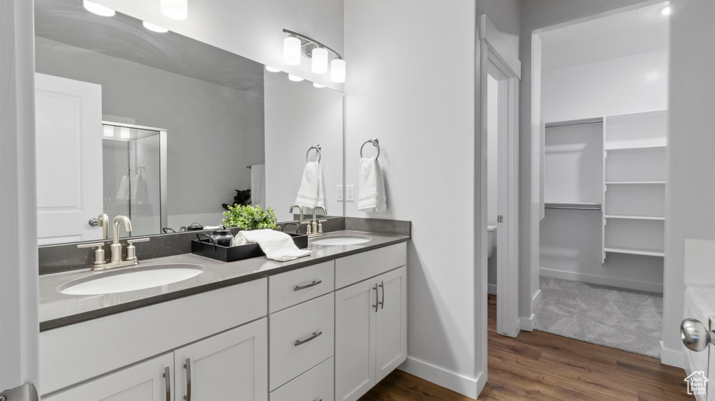 Bathroom with double sink vanity and hardwood / wood-style flooring